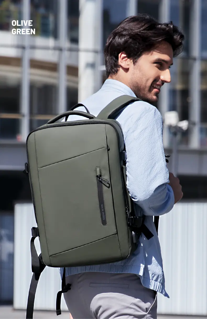 Smiling man wearing Mark Ryden MR9299 laptop backpack in olive green